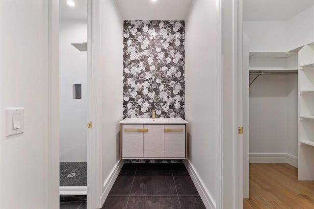 40 Singer Ave Unit 201, Spring Valley, NY 10977 - full bath with vanity, a walk in closet, and a shower