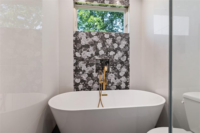 40 Singer Ave Unit 201, Spring Valley, NY 10977 - bathroom featuring tile walls and a soaking tub
