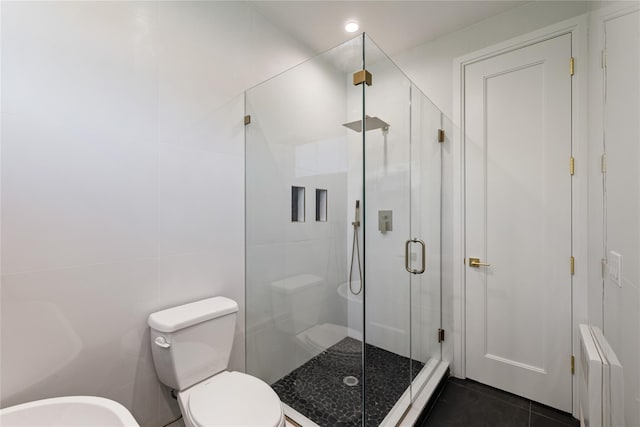 40 Singer Ave Unit 201, Spring Valley, NY 10977 - full bathroom featuring a shower stall, tile patterned flooring, radiator, tile walls, and a bidet