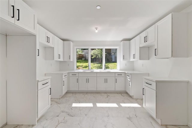 40 Singer Ave Unit 201, Spring Valley, NY 10977 - kitchen featuring light marble finish flooring and white cabinetry
