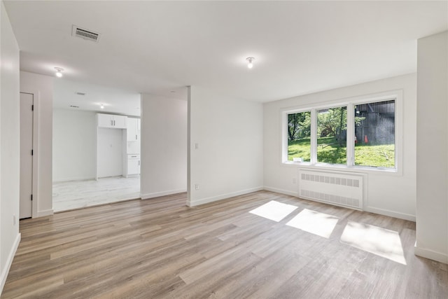 40 Singer Ave Unit 201, Spring Valley, NY 10977 - unfurnished room featuring radiator and light wood-type flooring