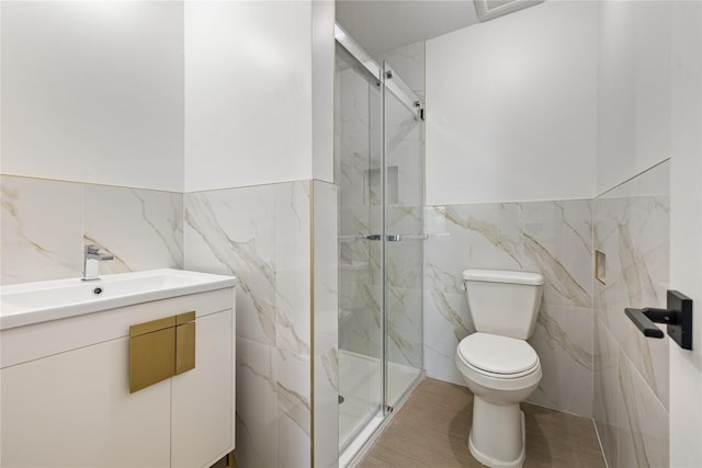 40 Singer Ave Unit 201, Spring Valley, NY 10977 - bathroom with tile walls, vanity, a marble finish shower, and wainscoting