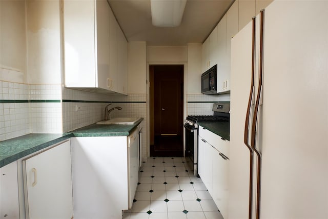110-11 Queens Blvd Unit 27G, Forest Hills, NY 11375 - kitchen featuring freestanding refrigerator, gas stove, black microwave, white cabinets, and dark countertops