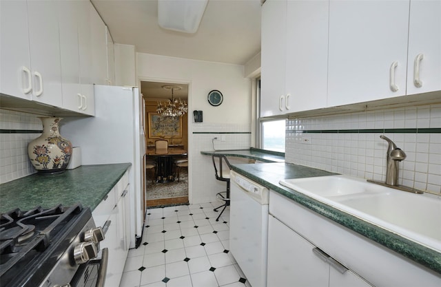110-11 Queens Blvd Unit 27G, Forest Hills, NY 11375 - kitchen with white dishwasher, white cabinets, a chandelier, decorative backsplash, and tile walls