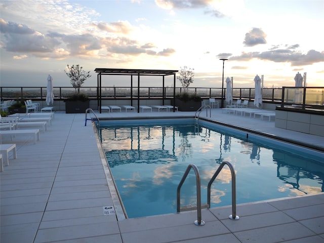 110-11 Queens Blvd Unit 27G, Forest Hills, NY 11375 - pool at dusk with a community pool and a patio
