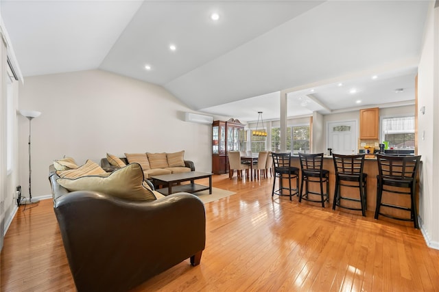 222-47 Garland Dr, Bayside, NY 11364 - living area with a wall mounted air conditioner, light wood-style flooring, vaulted ceiling, recessed lighting, and baseboards