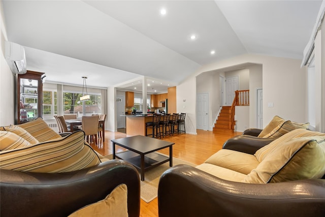 222-47 Garland Dr, Bayside, NY 11364 - living area with an AC wall unit, light wood-style floors, vaulted ceiling, stairs, and recessed lighting