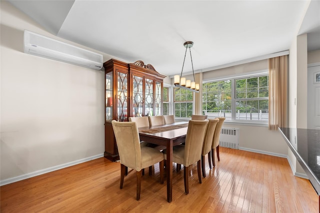 222-47 Garland Dr, Bayside, NY 11364 - dining space featuring a wall unit AC, radiator heating unit, baseboards, and light wood-style flooring