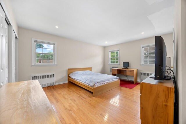 222-47 Garland Dr, Bayside, NY 11364 - bedroom with radiator, light wood-type flooring, recessed lighting, a desk, and baseboards