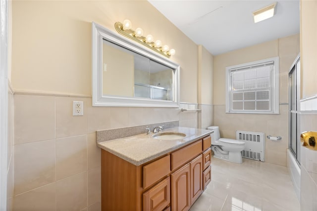 222-47 Garland Dr, Bayside, NY 11364 - full bath with radiator heating unit, tile walls, toilet, vanity, and tile patterned floors