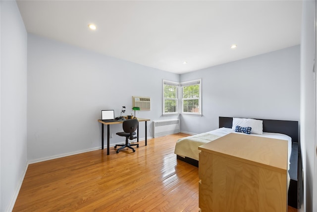 222-47 Garland Dr, Bayside, NY 11364 - bedroom featuring radiator, light wood-type flooring, baseboards, a wall mounted AC, and an office area