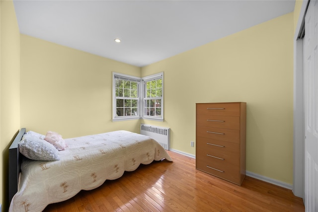 222-47 Garland Dr, Bayside, NY 11364 - bedroom with radiator heating unit, baseboards, hardwood / wood-style floors, a closet, and recessed lighting