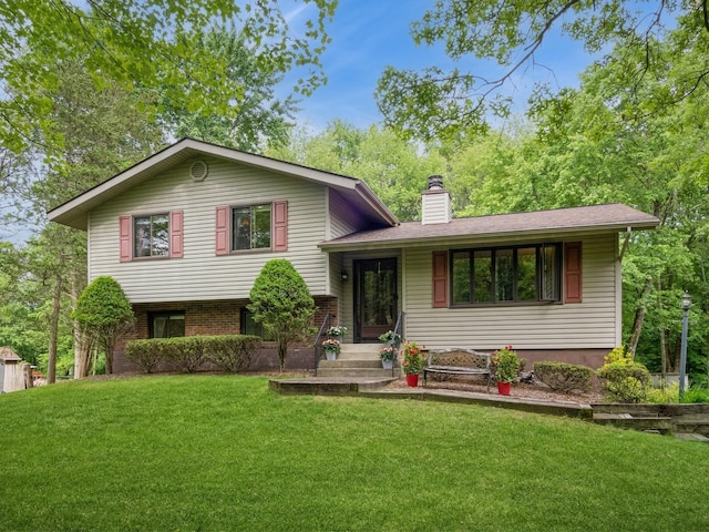 29 Sachson Pl, Wappingers Falls, NY 12590 - tri-level home with a chimney, a front lawn, and brick siding