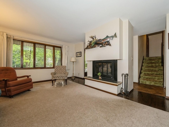29 Sachson Pl, Wappingers Falls, NY 12590 - carpeted living area with a glass covered fireplace, stairs, and baseboards
