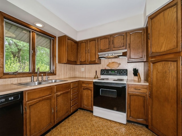 29 Sachson Pl, Wappingers Falls, NY 12590 - kitchen with electric stove, black dishwasher, under cabinet range hood, a sink, and light countertops