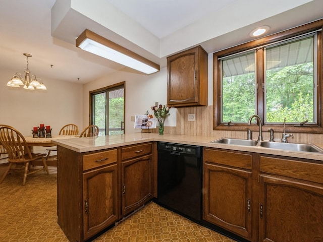 29 Sachson Pl, Wappingers Falls, NY 12590 - kitchen featuring black dishwasher, a sink, a peninsula, light countertops, and a chandelier