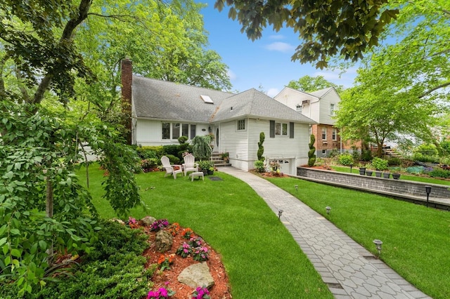 18 Hawthorne Ln, Valley Stream, NY 11581 - back of house with a chimney, a yard, and an attached garage