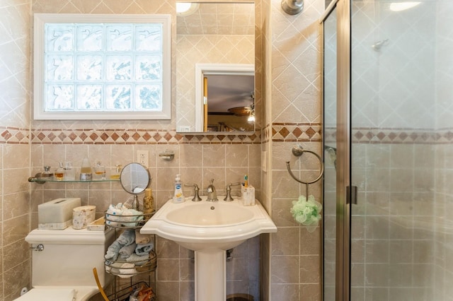 18 Hawthorne Ln, Valley Stream, NY 11581 - full bathroom with a stall shower, tile walls, and toilet