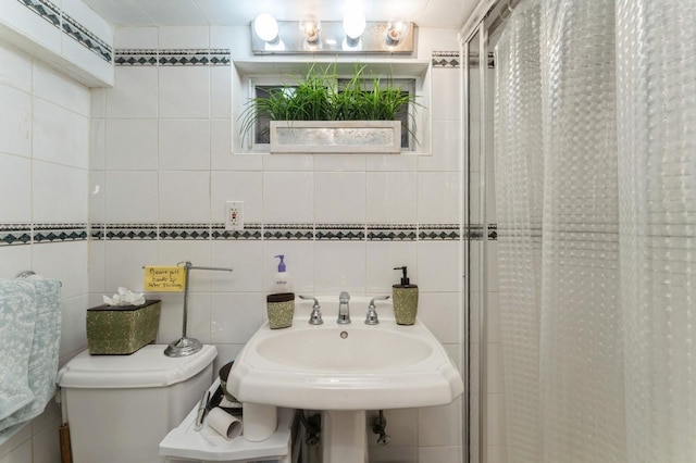 18 Hawthorne Ln, Valley Stream, NY 11581 - full bathroom with a stall shower, toilet, tile walls, and a sink