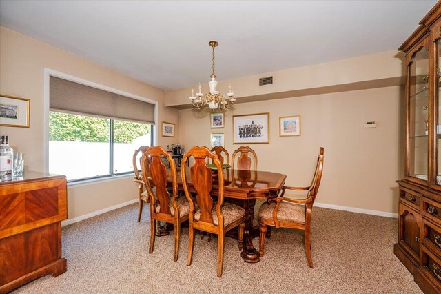 1270 Mara Ct, Atlantic Beach, NY 11509 - dining room featuring a chandelier, light colored carpet, and baseboards