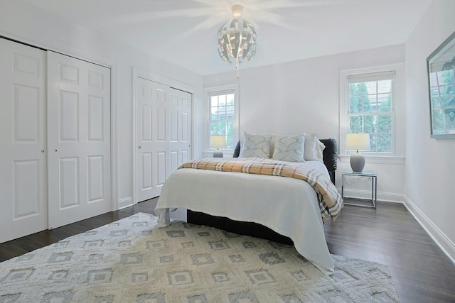 15 Old Farm Rd, Scarsdale, NY 10583 - bedroom with two closets, dark wood-type flooring, baseboards, and a chandelier