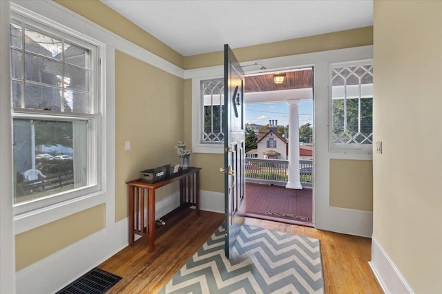 102 Broadway, Dobbs Ferry, NY 10522 - doorway with wood finished floors, decorative columns, and baseboards