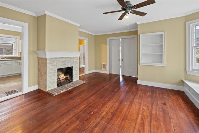 102 Broadway, Dobbs Ferry, NY 10522 - unfurnished living room featuring ceiling fan, a fireplace, wood finished floors, baseboards, and crown molding