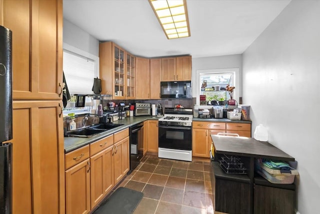102 Broadway, Dobbs Ferry, NY 10522 - kitchen with black appliances, a sink, dark countertops, and glass insert cabinets