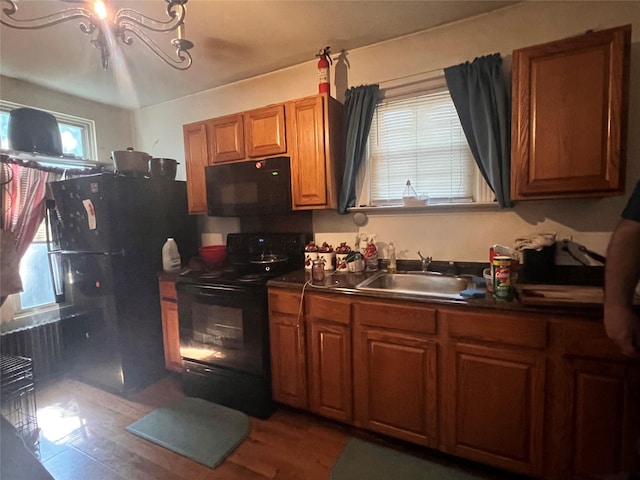 13 Hooker Ave, Poughkeepsie, NY 12601 - kitchen with black appliances, dark countertops, brown cabinets, and healthy amount of natural light