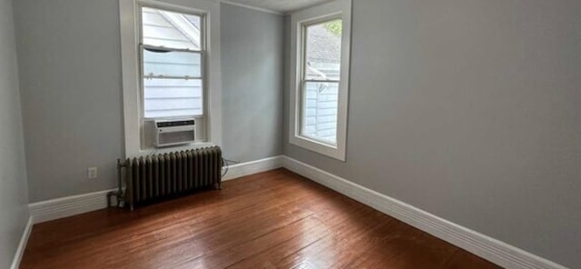 13 Hooker Ave, Poughkeepsie, NY 12601 - empty room with radiator, wood finished floors, and ornamental molding
