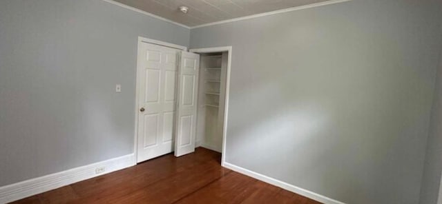 13 Hooker Ave, Poughkeepsie, NY 12601 - unfurnished bedroom with dark wood finished floors, ornamental molding, and a closet