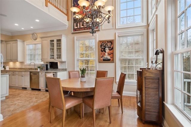 2 Shadow Tree Ln, Briarcliff Manor, NY 10510 - dining room with plenty of natural light, a chandelier, ornamental molding, light wood-style flooring, and a towering ceiling