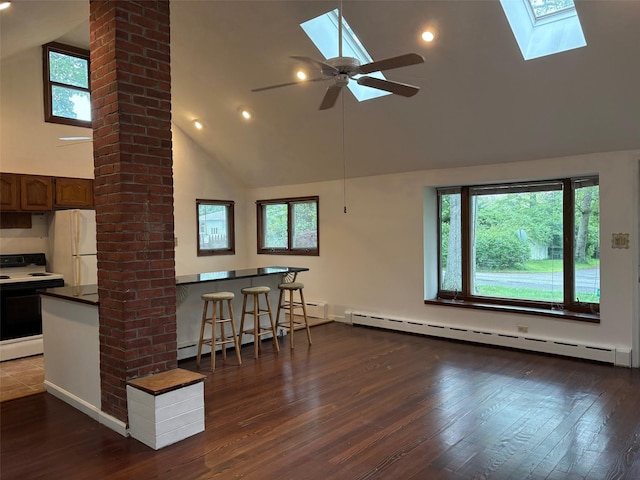 118 Truberg Ave, Patchogue, NY 11772 - kitchen with white appliances, a skylight, high vaulted ceiling, a baseboard radiator, and dark wood-style flooring
