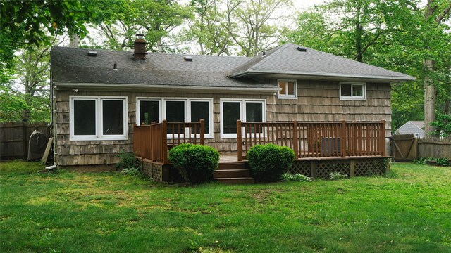 118 Truberg Ave, Patchogue, NY 11772 - back of property featuring roof with shingles, a chimney, and a wooden deck