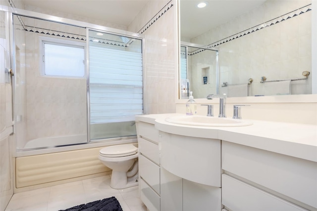 36 Randy Ln, Plainview, NY 11803 - full bathroom with vanity, bath / shower combo with glass door, tile patterned flooring, toilet, and tile walls