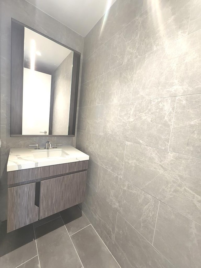 133-36 37th Ave Unit 8B, Flushing, NY 11354 - bathroom featuring tile walls, vanity, and tile patterned floors