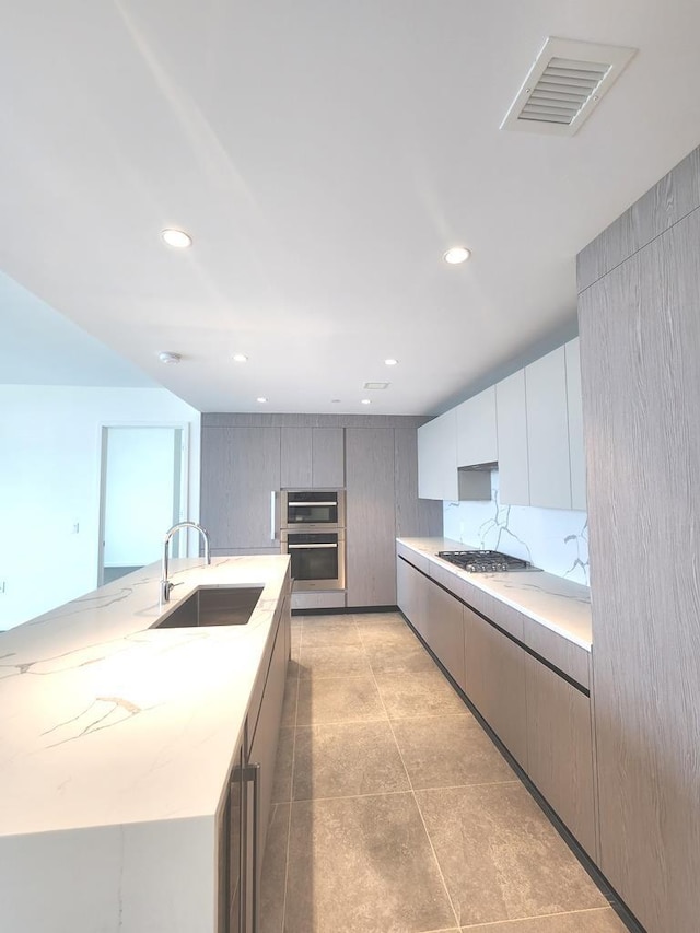 133-36 37th Ave Unit 8B, Flushing, NY 11354 - kitchen with a sink, gas stovetop, recessed lighting, modern cabinets, and a center island with sink