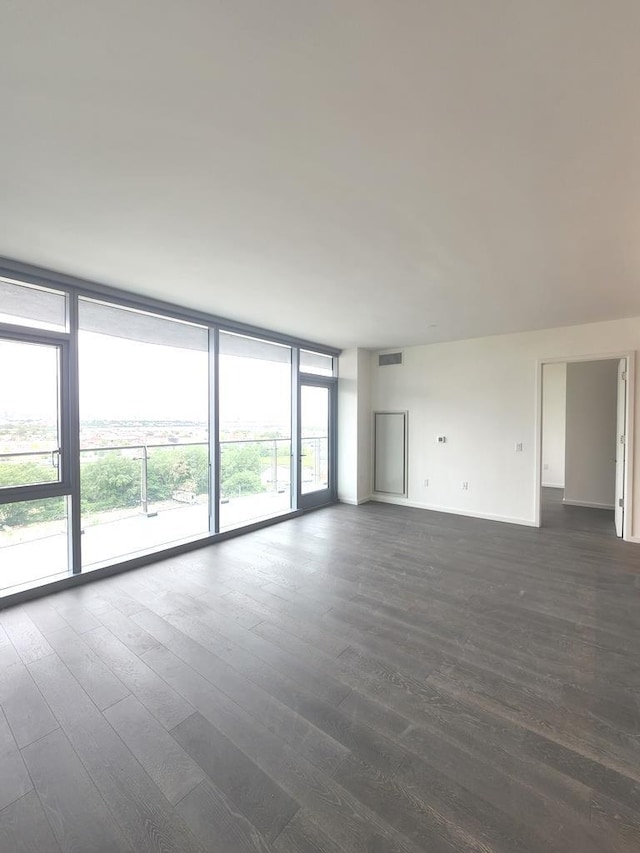 133-36 37th Ave Unit 8B, Flushing, NY 11354 - unfurnished living room with dark wood finished floors, floor to ceiling windows, and baseboards