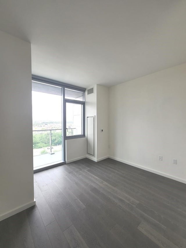 133-36 37th Ave Unit 8B, Flushing, NY 11354 - empty room with dark wood-type flooring and baseboards
