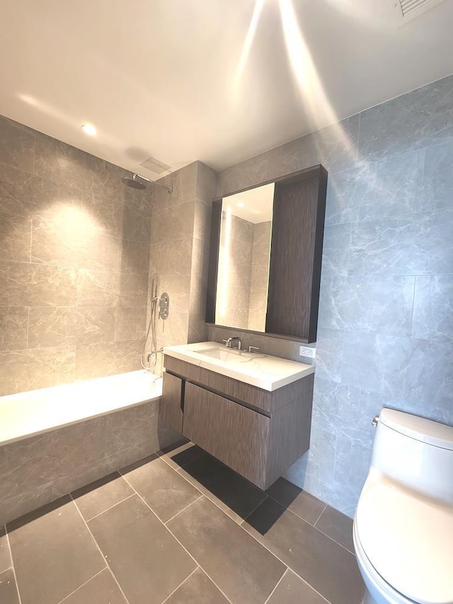 133-36 37th Ave Unit 8B, Flushing, NY 11354 - bathroom with tile walls, tiled shower / bath combo, toilet, vanity, and tile patterned flooring