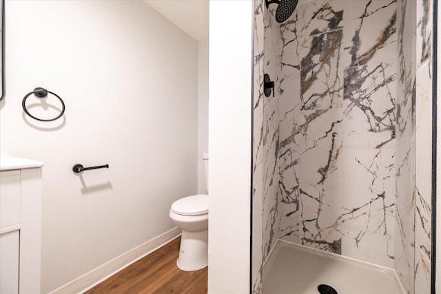23 Lincoln St, Elmont, NY 11003 - bathroom with a marble finish shower, wood finished floors, toilet, vanity, and baseboards
