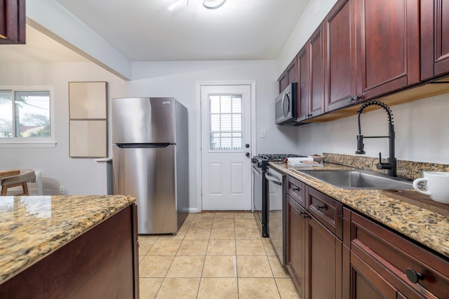 23 Lincoln St, Elmont, NY 11003 - kitchen featuring appliances with stainless steel finishes, dark brown cabinets, a sink, and healthy amount of natural light