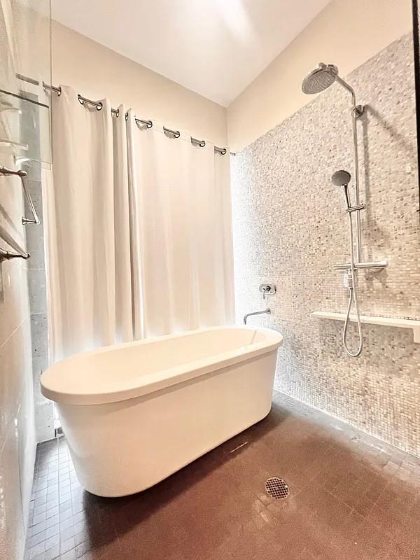 2728 Thomson Ave Unit 434, Long Island City, NY 11101 - bathroom featuring tile walls and tile patterned floors