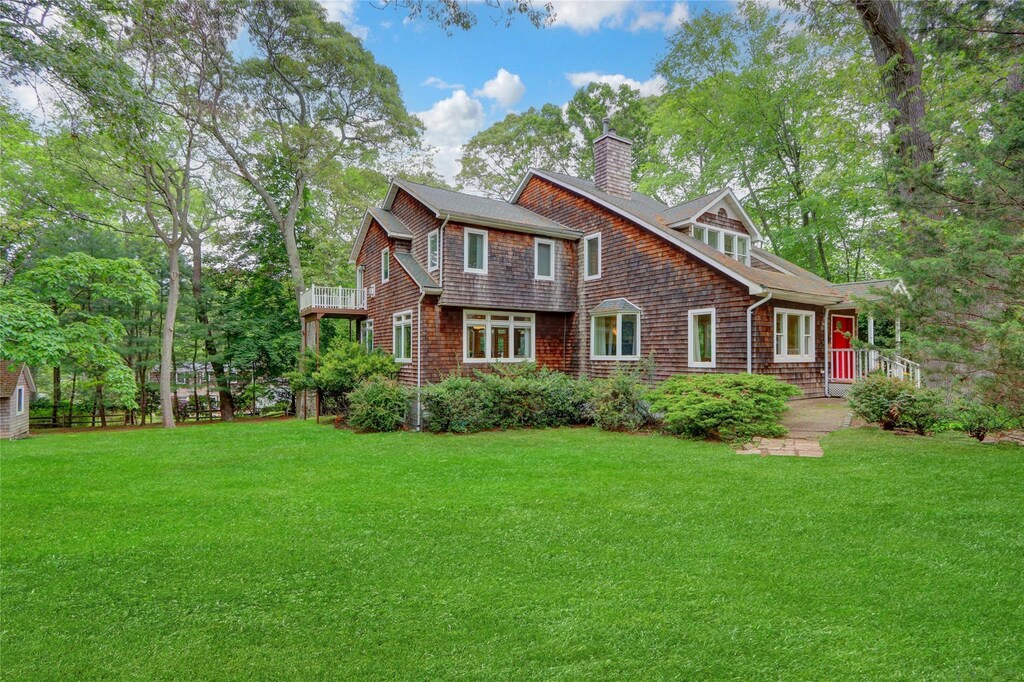 23 Knox Ave, Stony Brook, NY 11790 - shingle-style home featuring a chimney, a front lawn, and a balcony