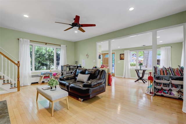 23 Knox Ave, Stony Brook, NY 11790 - living area with radiator, stairway, healthy amount of natural light, light wood-style floors, and recessed lighting