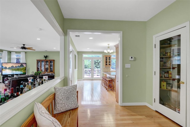 23 Knox Ave, Stony Brook, NY 11790 - corridor with light wood-type flooring, baseboards, recessed lighting, french doors, and a chandelier