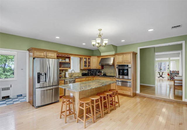 23 Knox Ave, Stony Brook, NY 11790 - kitchen with stainless steel appliances, radiator, wall chimney range hood, a warming drawer, and a sink