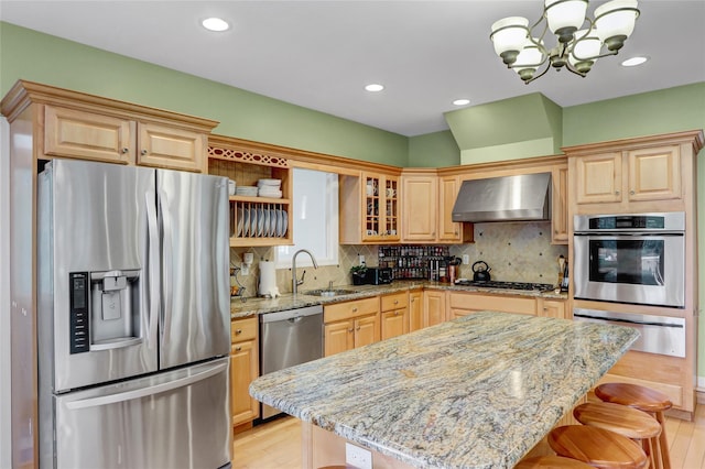 23 Knox Ave, Stony Brook, NY 11790 - kitchen with appliances with stainless steel finishes, a warming drawer, wall chimney exhaust hood, a sink, and a chandelier