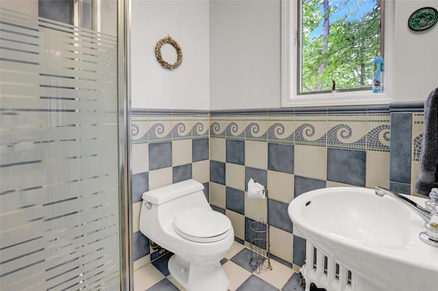 23 Knox Ave, Stony Brook, NY 11790 - full bath featuring tile walls, a stall shower, a wainscoted wall, a sink, and toilet
