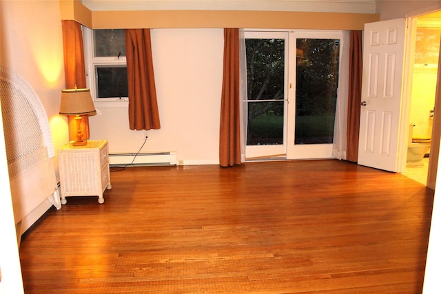 113 Pine Neck Ave, East Patchogue, NY 11772 - unfurnished room with a baseboard heating unit and wood finished floors